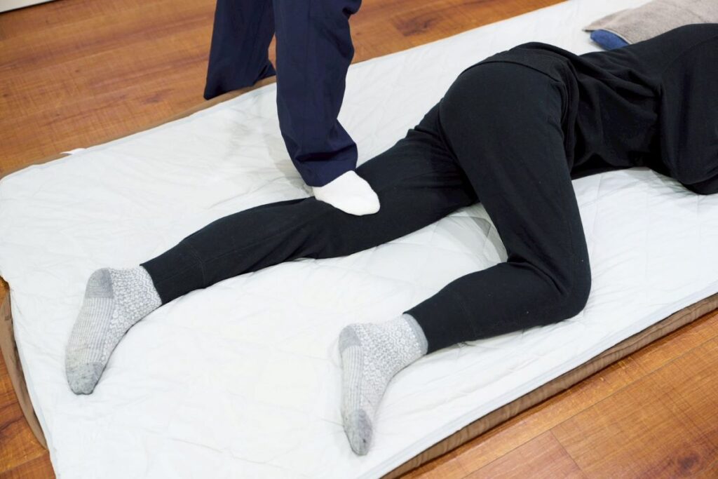 横浜の整体院「ととのう」での足圧ストレッチ施術風景。